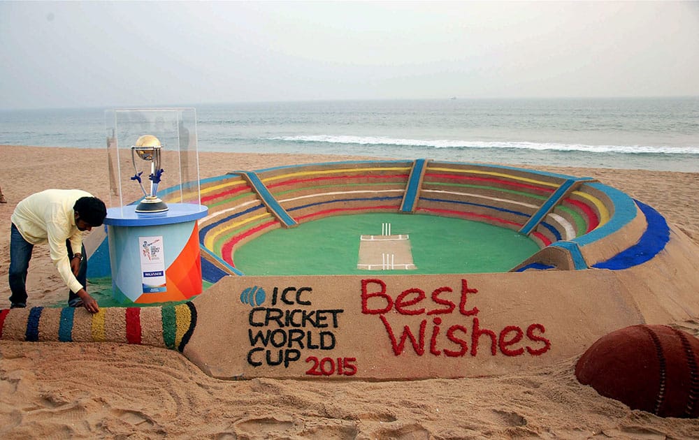 Sand Artist Sudarshan Patnaik creates a sand art welcoming the ICC World Cup at Golden Beach in Puri.