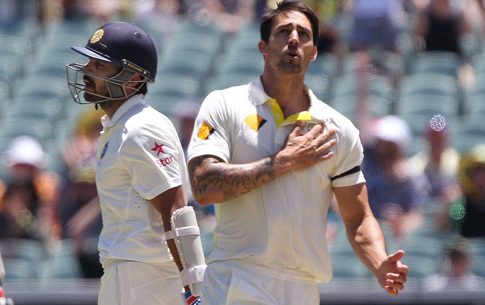 India's Murali Vijay begins to leave the field after his wicket fell to Australia's Mitchell Johnson for 53 runs during the third day of their cricket test match in Adelaide, Australia.