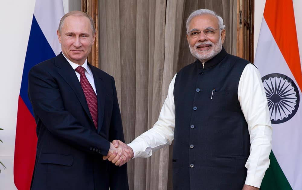 Russian President Vladimir Putin poses for the media with Prime Minister Narendra Modi before their meeting in New Delhi.