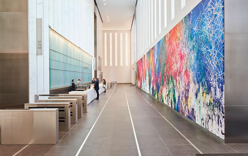 This photo provided by Edelman Arts shows a color-splashed, 90-by-15-foot painting by the Miami-born Cuban artist Jose Parla in the vast lobby of the new 1 World Trade Center building in New York. 