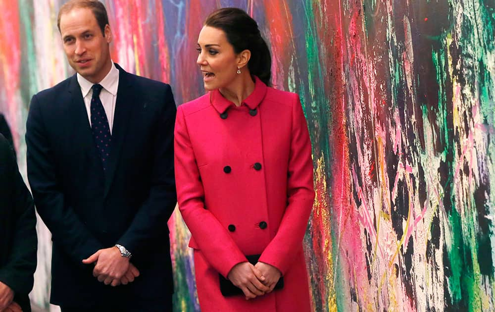 Britain's Prince William, Duke of Cambridge, left, and Kate, Duchess of Cambridge, walk in front of a mural by Jose Parla as the royal couple takes a tour of the lobby of new One World Trade Center following a visit to the nearby National September 11 Memorial and Museum, in New York.