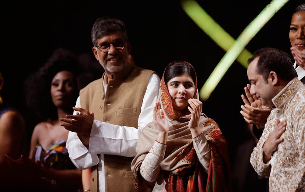 Joint-Nobel Peace Prize winners Malala Yousafzai and Kailash Satyarthi, applaud on stage with Pakistani musician Rahat Fateh Ali Khan at the end of the Nobel Peace Prize Concert in Oslo, Norway.