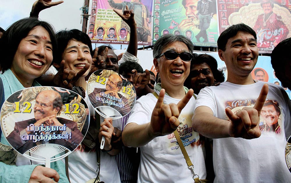 Japanese fans of superstar Rajinikanth arrive at a cinema hall to watch the actors latest movie Lingaa on his 64th birthday in Chennai.