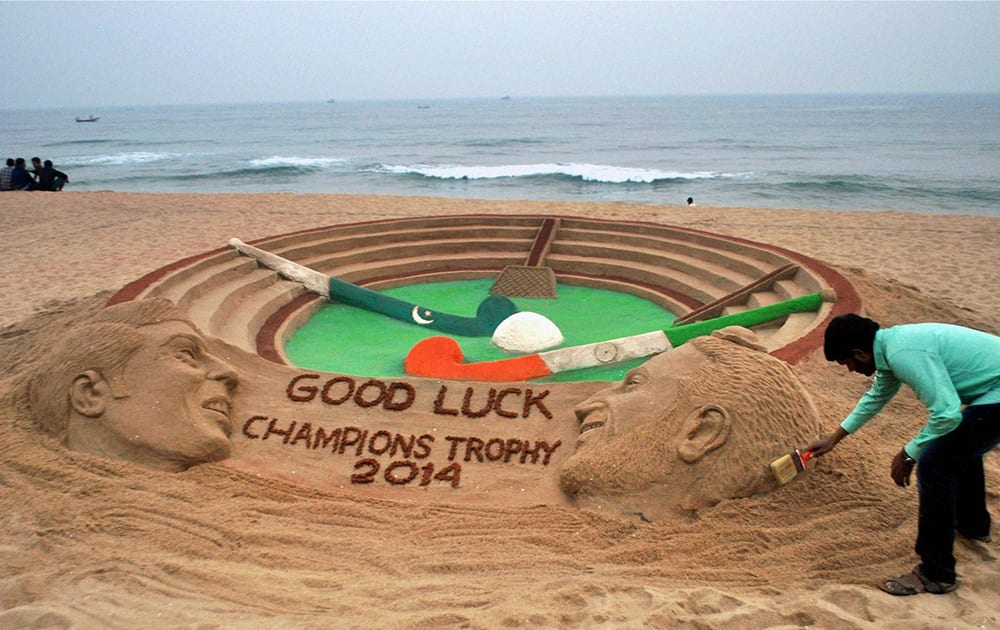 Sand artist Sudarshan Patnaik makes a sand sculpture to wish the Indian Hockey team good luck for their Semi-Final Match against Pakistan in Puri.