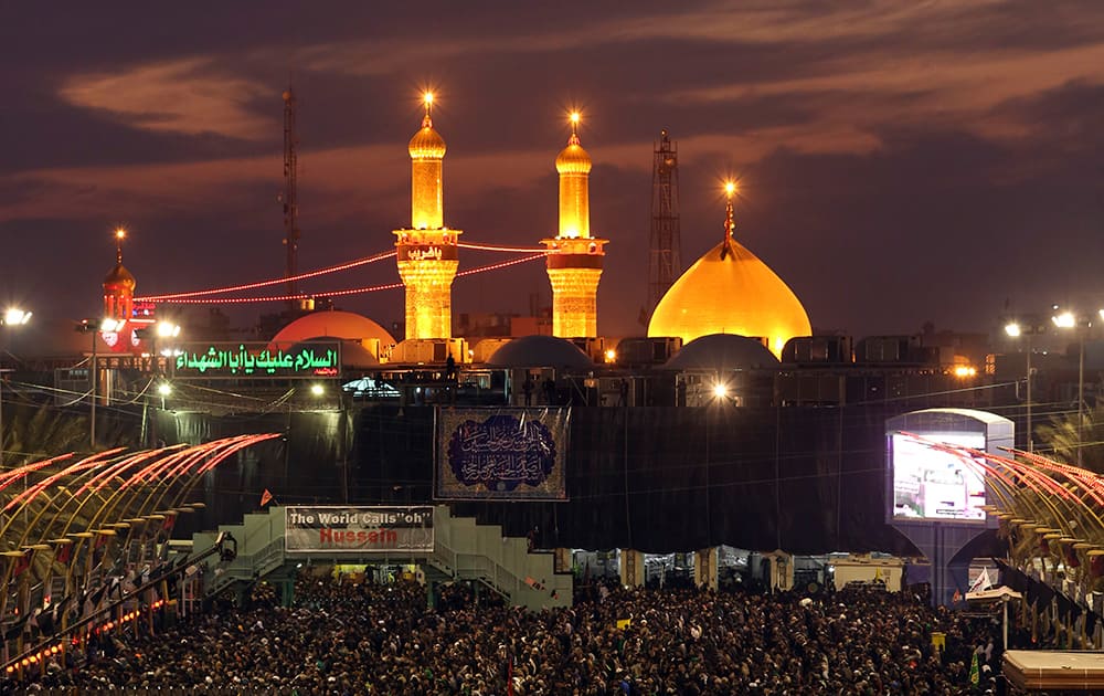 Shiite faithful pilgrims gather between the holy shrine of Imam Hussein and the holy shrine of Imam Abbas, in the background, during the preparations for the Muslim festival of Arbaeen in the Shiite holy city of Karbala, 50 miles (80 kilometers) south of Baghdad, Iraq.