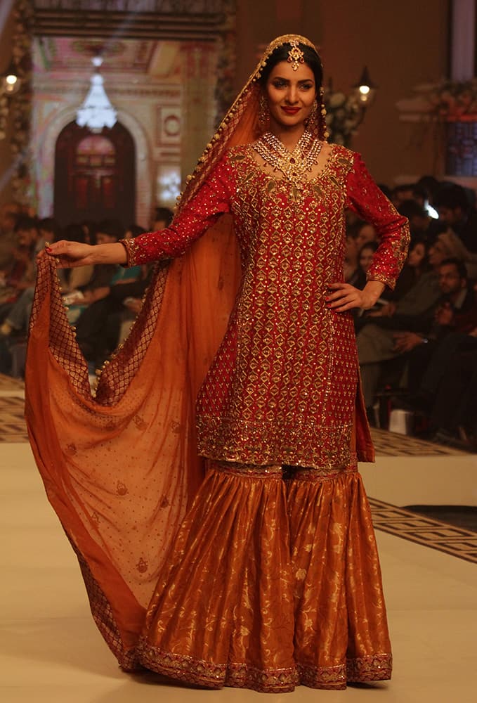 Pakistani model Umsha presents a creation by Pakistani designer Uzma Babar during the Telenor Bridal Couture Week 2014, in Lahore, Pakistan.