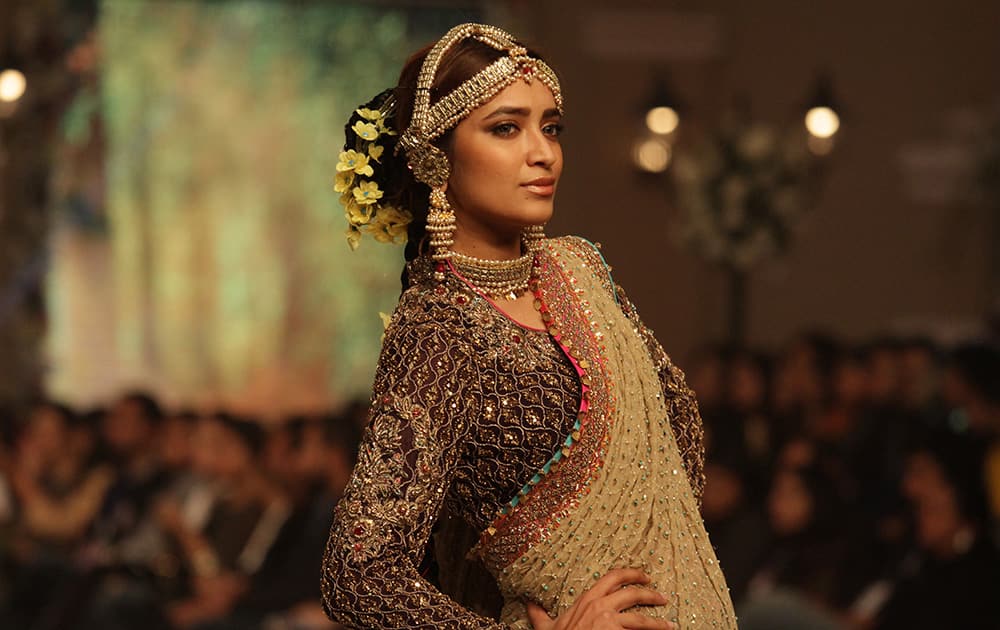 A Pakistani model presents a creation by Pakistani designer Fahad Hussayn during the Telenor Bridal Couture Week 2014, in Lahore, Pakistan.