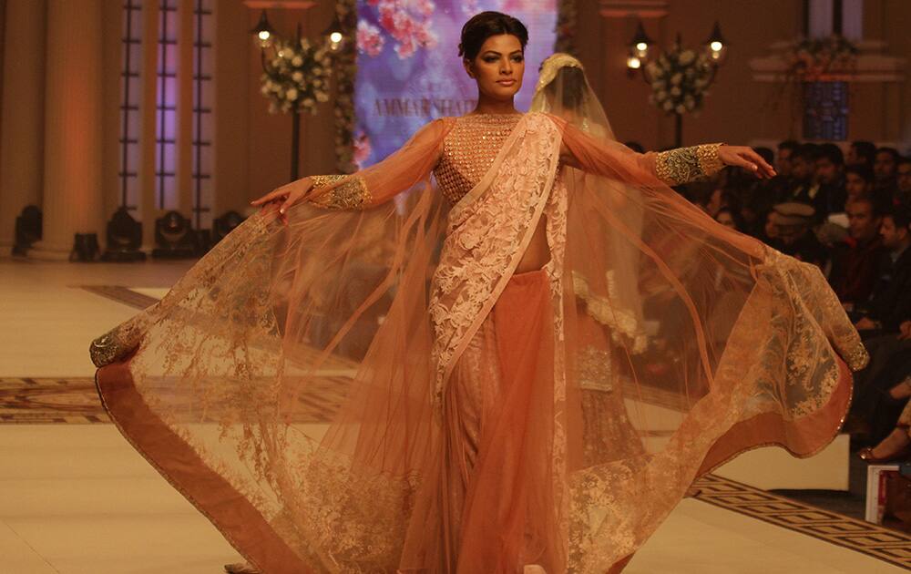 A Pakistani model presents a creation by Pakistani designer Ammar Shahid during the Telenor Bridal Couture Week 2014, in Lahore, Pakistan.