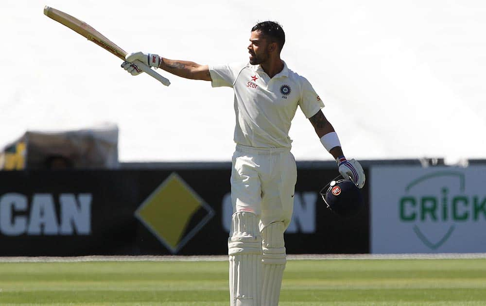 Virat Kohli reacts after reaching a century during the final day of their cricket test match against Australia in Adelaide, Australia.