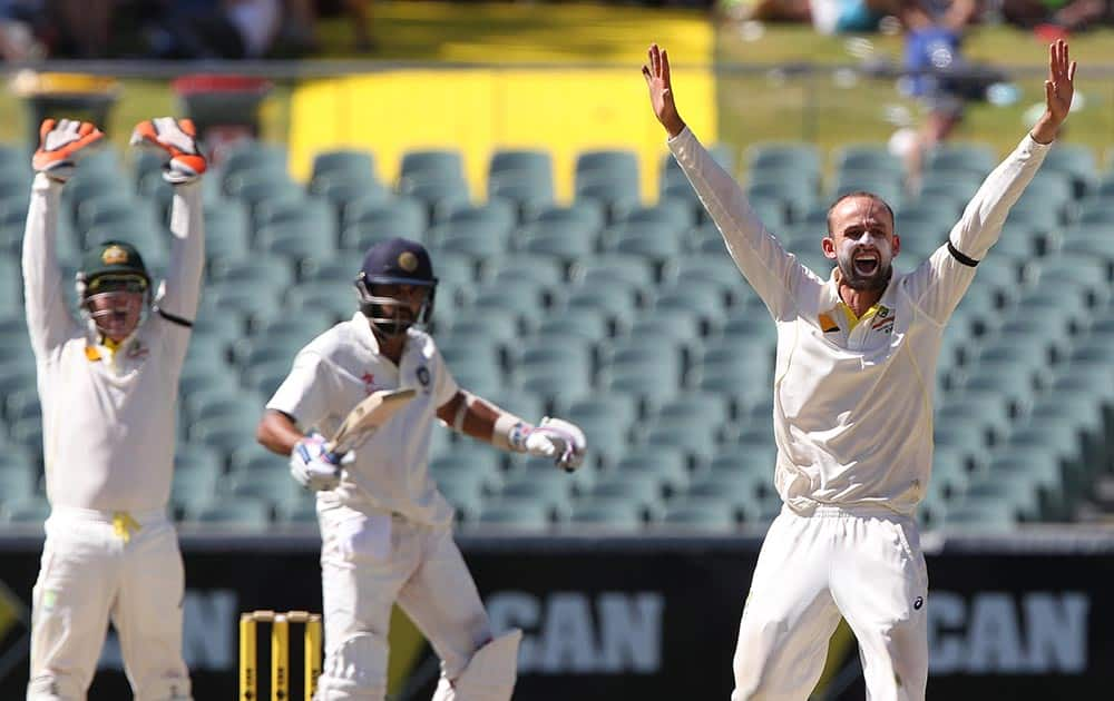 Australia's Nathan Lyon, appeals successfully to dismiss Indian batsman Murali Vijay for 99 runs as wicketkeeper Brad Haddin, looks on during the final day of their cricket test match in Adelaide.