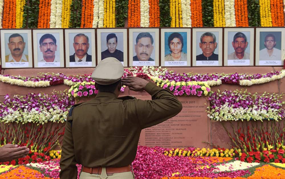 A senior police officer paying tributes to the martyrs of 2001 Parliament attacks on its 13th anniversary, at Parliament House in New Delhi.