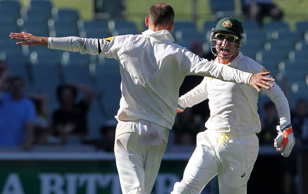 Australia's Brad Haddin runs to teammate Nathan Lyon as they celebrate after defeating India by 48 runs on the final day of their cricket test match in Adelaide, Australia.