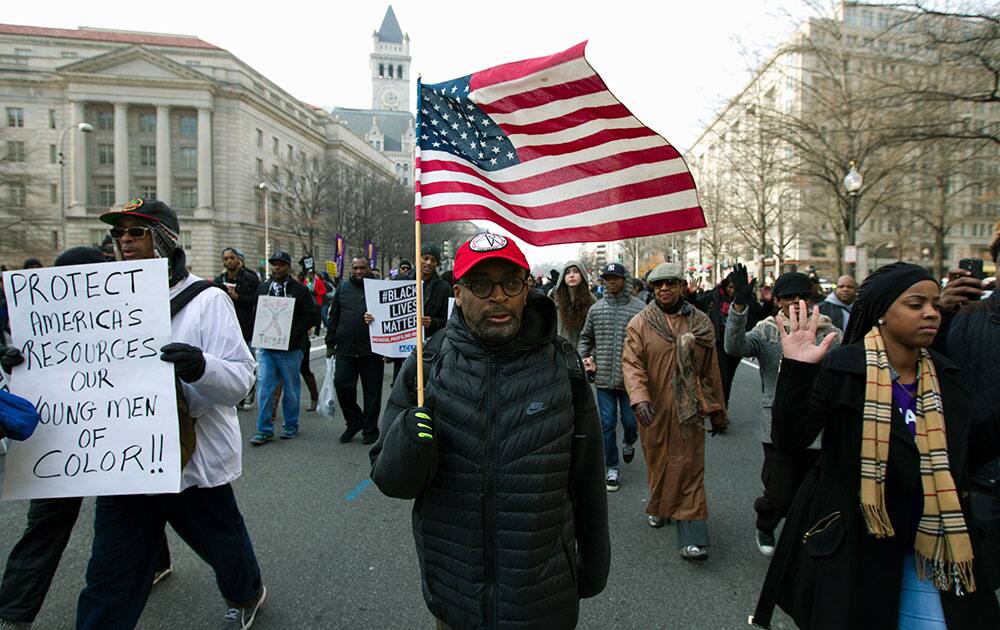 Film director Spike Lee, and others, march on Pennsylvania Avenue toward Capitol Hill in Washington.