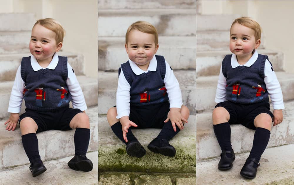 This photo provided by The Duke and Duchess of Cambridge and taken in late Nov. 2014, Britain's Prince George poses for a photograph in a courtyard at Kensington Palace, London.