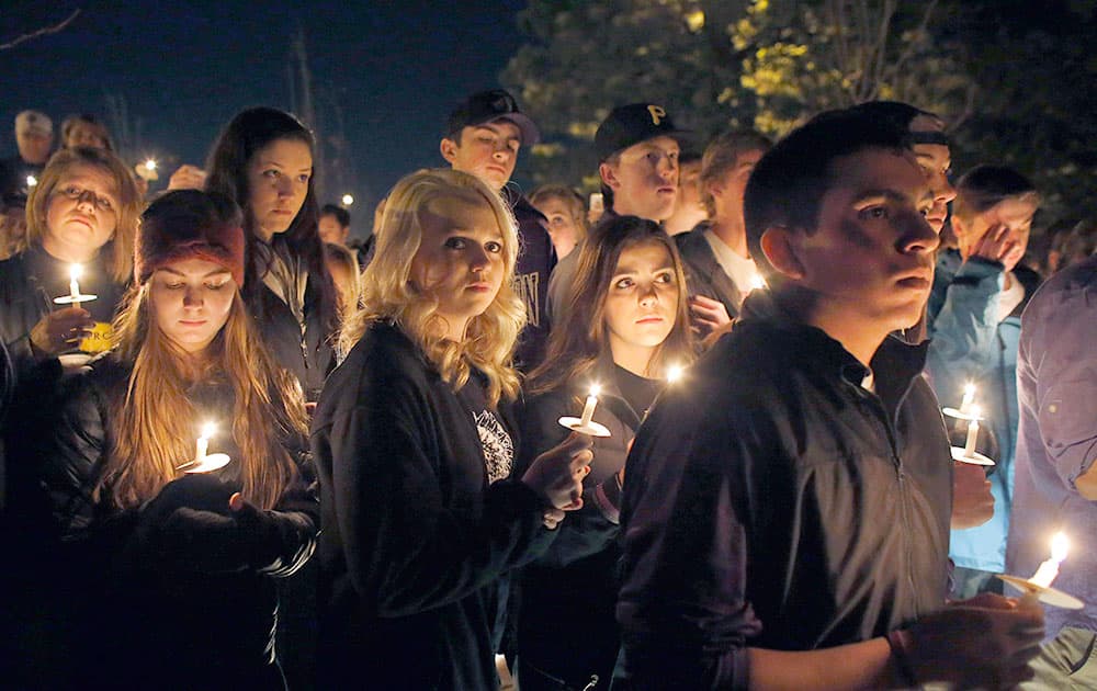 Arapahoe High School students and supporters hold a candle light vigil during a one year remembrance ceremony on Clarity Commons, named for student Claire Davis, who was killed in a school shooting one year earlier, at Arapahoe High School, in Centennial, Colo.
