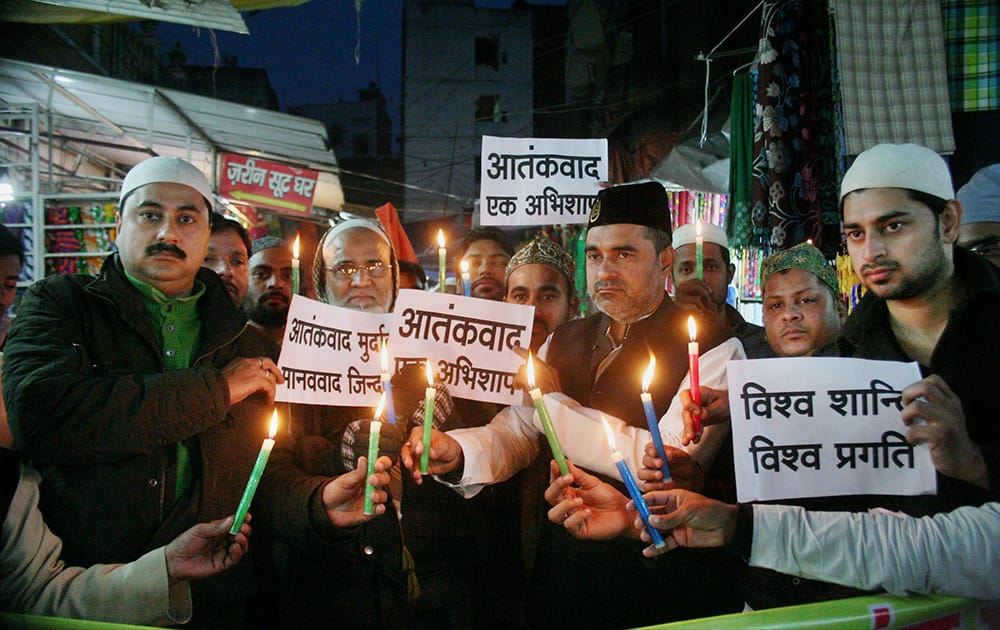 Members of the Muslim Foundation pay tribute to the people who lost their life in the terrorist attack at Parliament in 2001 at a cloth market in Varanasi.