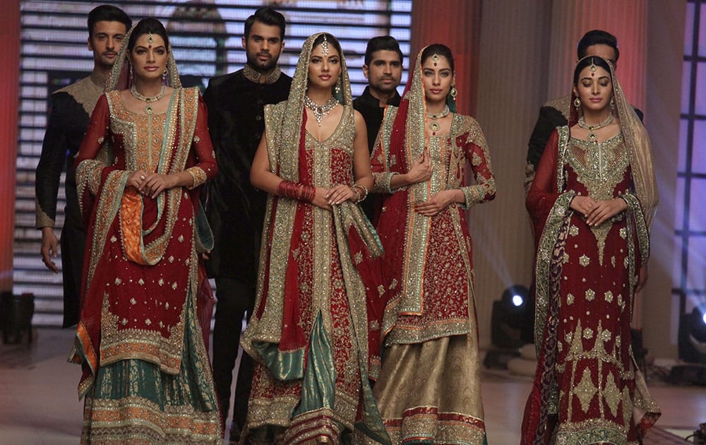 Pakistani models present creations by designer Mehdi during the second day of Telenor Bridal Couture Week 2014, in Lahore.