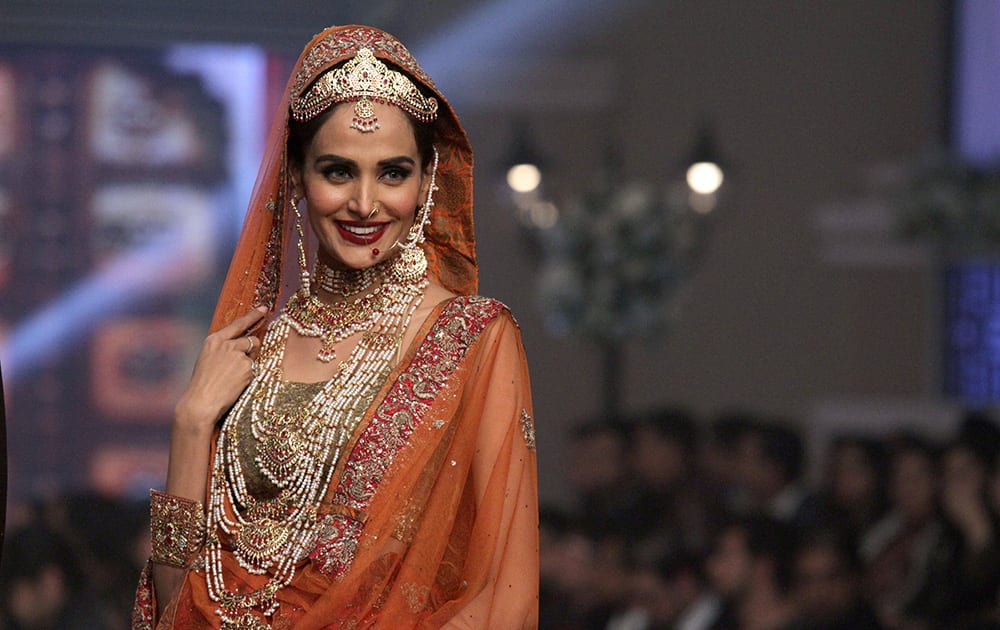A Pakistani model presents a creation by designer Samreen Vance during the second day of Telenor Bridal Couture Week 2014, in Lahore, Pakistan.