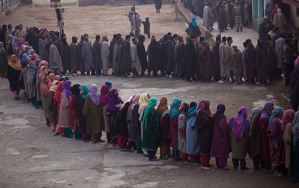 Kashmiris stand in a queue to cast their votes during the fourth phase polling of the Jammu and Kashmir state elections on the outskirts of Srinagar.