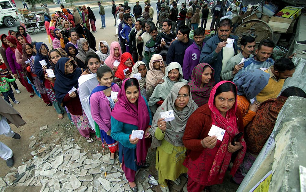 People show their voter ID cards as they queue up to cast their votes in the 4th Phase of J& K Assembly Elections at Vijaypur, 35 km from Jammu.