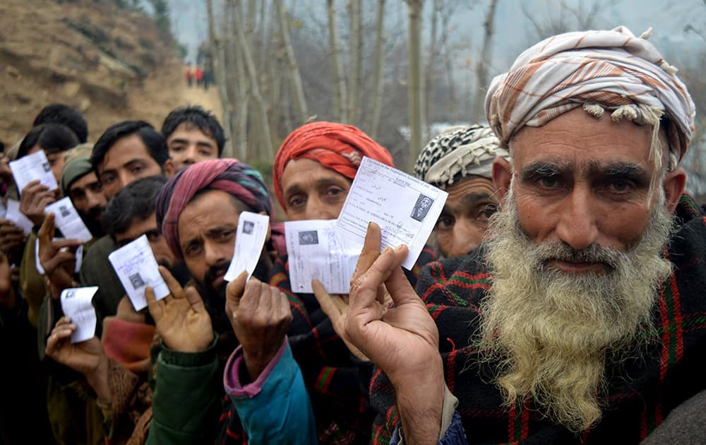 Kashmiris stand in a long queue as they wait to cast their vote at in a polling station in the 4th phase of state assembly election in Jammu and Kashmir.