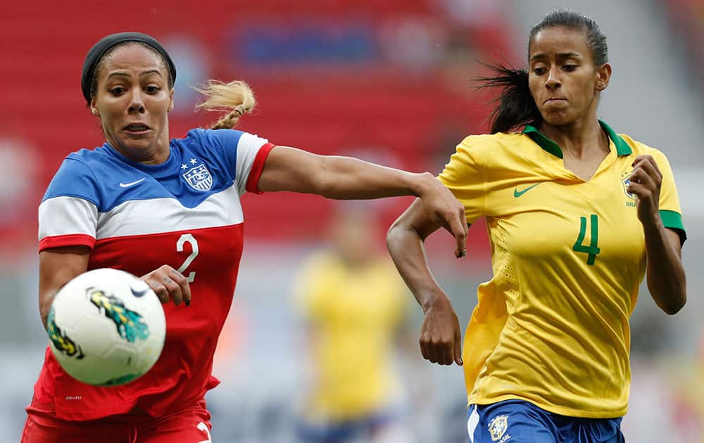 United States' Sydney Leroux, left, fights for the ball with Brazil’s Thayla Carolina, right, during a match of the International Women's Football Tournament at the National Stadium in Brasilia, Brazil.