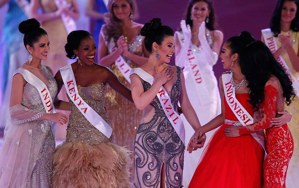 From left, Miss India Koyal Rana, Miss Kenya, Idah Nguma, Miss Brazil, Julia Gama, Miss Indonesia Maria Asteria Sastrayu Rahajeng, and Miss Malaysia, Dewi Liana Seriestha, celebrate, after winning the charity section of the Miss World competition, at the ExCel centre in London.