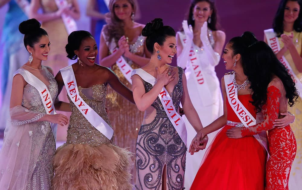 From left, Miss India Koyal Rana, Miss Kenya, Idah Nguma, Miss Brazil, Julia Gama, Miss Indonesia Maria Asteria Sastrayu Rahajeng, and Miss Malaysia, Dewi Liana Seriestha, celebrate, after winning the charity section of the Miss World competition, at the ExCel centre in London.