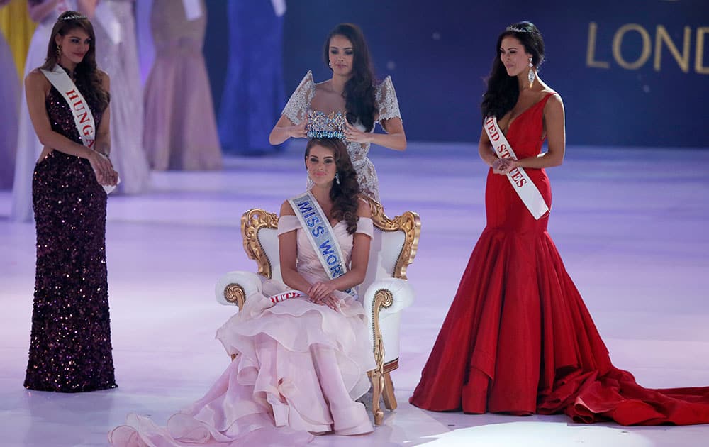 Miss South Africa Rolene Strauss is crowned Miss World 2014 by last year's winner Megan Young, at the end of the competition at the ExCel centre in London. Miss Hungary Edina Kulcsar, left, was second with Miss United States, Elizabeth Safrit finishing third.