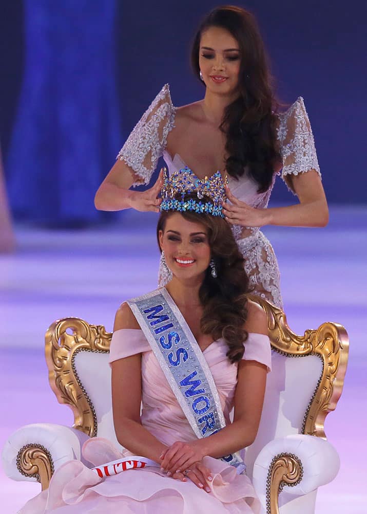 Miss South Africa Rolene Strauss is crowned Miss World 2014 by last year's winner Megan Young, during the finale of the competition at the ExCel centre in London, Sunday, Dec. 14 2014.