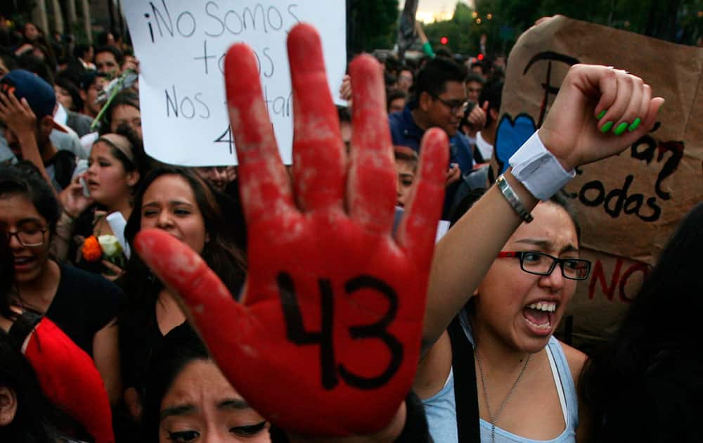 In this Oct. 22, 2014 file photo, demonstrators protest the disappearance of 43 students from the Isidro Burgos rural teachers college, in Mexico City.