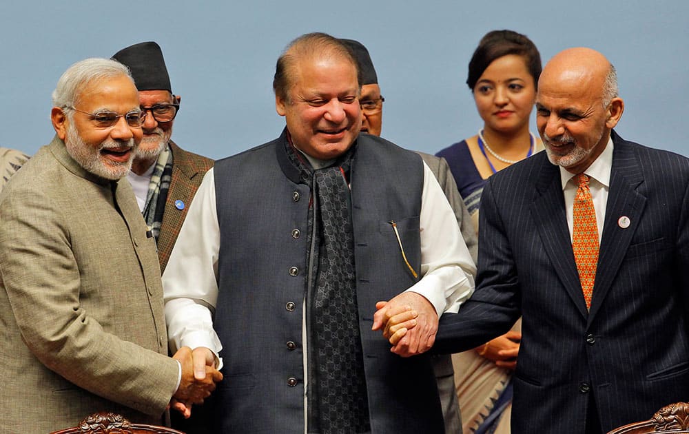 Pakistani Prime Minister Nawaz Sharif, center, holds hands with Indian Prime Minister Narendra Modi, left, and Afghanistan President Ashraf Ghani during the closing session of the 18th summit of the South Asian Association for Regional Cooperation (SAARC) in Katmandu, Nepal, Thursday, Nov. 27, 2014. 