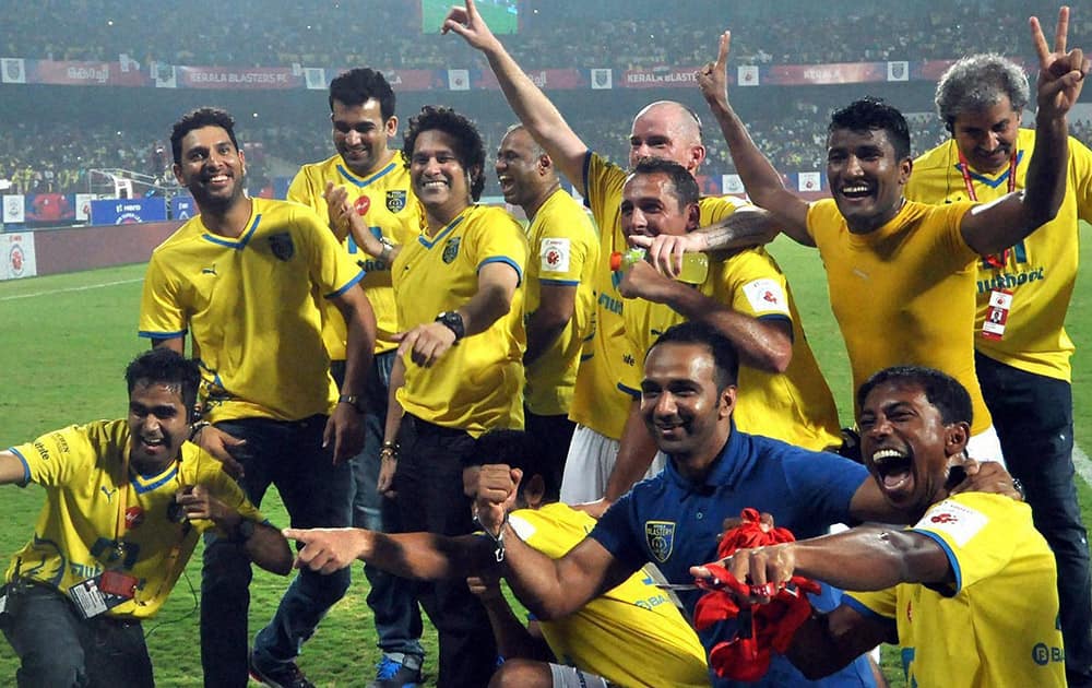 Kerala blasters FC players along with cricket legend Sachin Tendulkar, cricketers Yuvaraj Singh and Zaheer khan celebrate after winning against Chennaiyin FC during an ISL match.