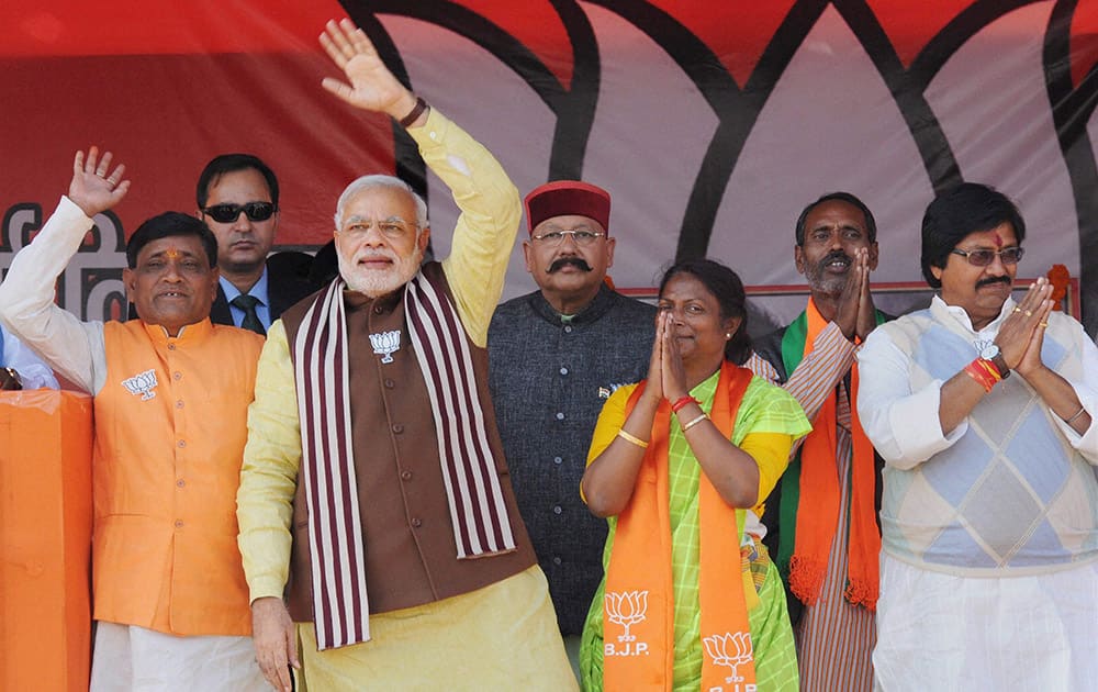 Prime Minister Narendra Modi waves to crowd during an election campaign rally in Dumka, Jharkhand.