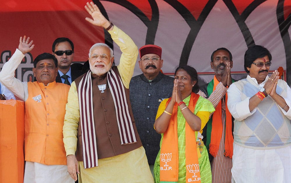 Prime Minister Narendra Modi waves to crowd during an election campaign rally in Dumka, Jharkhand.