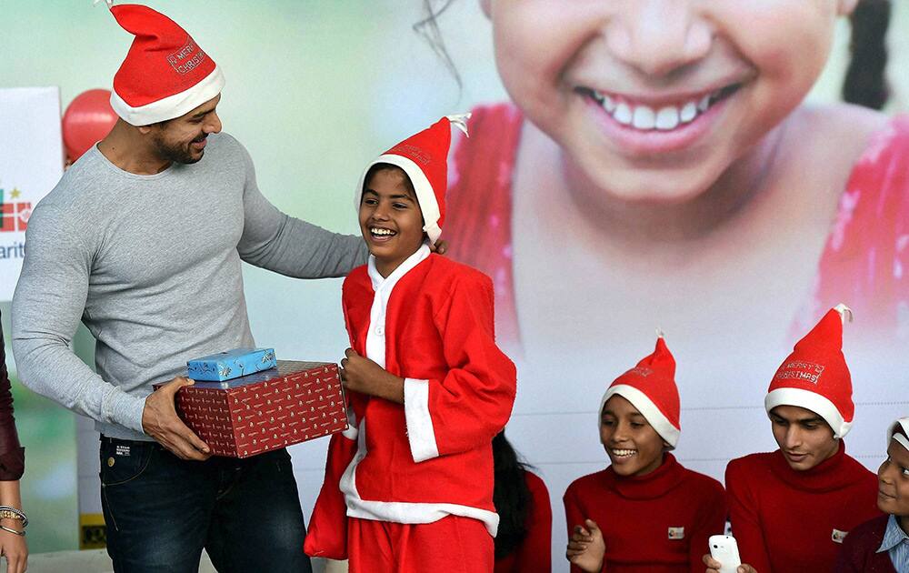 Johan Abraham, Brand Ambassador for Make a Wish Foundation, presents gifts to the underprivileged children.