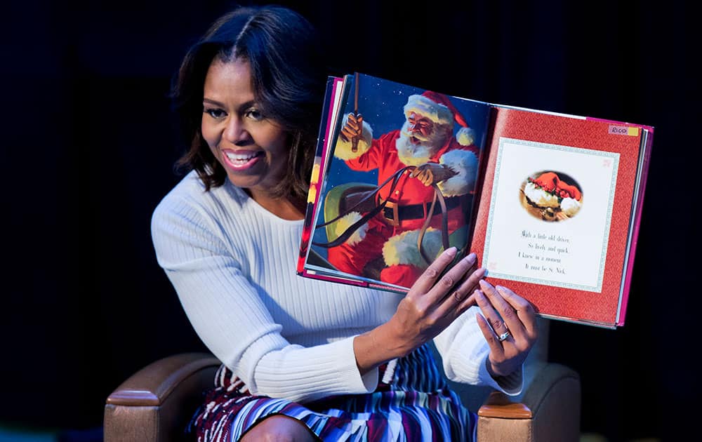 First lady Michelle Obama reads “Twas the night before Christmas” to patients, families, and staff at Children’s National Health System in Washington.