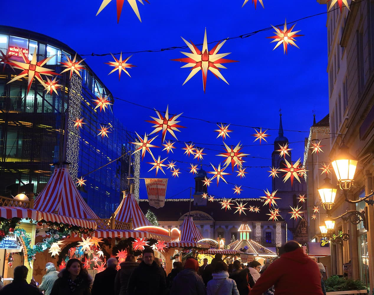 people enjoy a stroll at the Christmas market in Magdeburg, eastern Germany. 