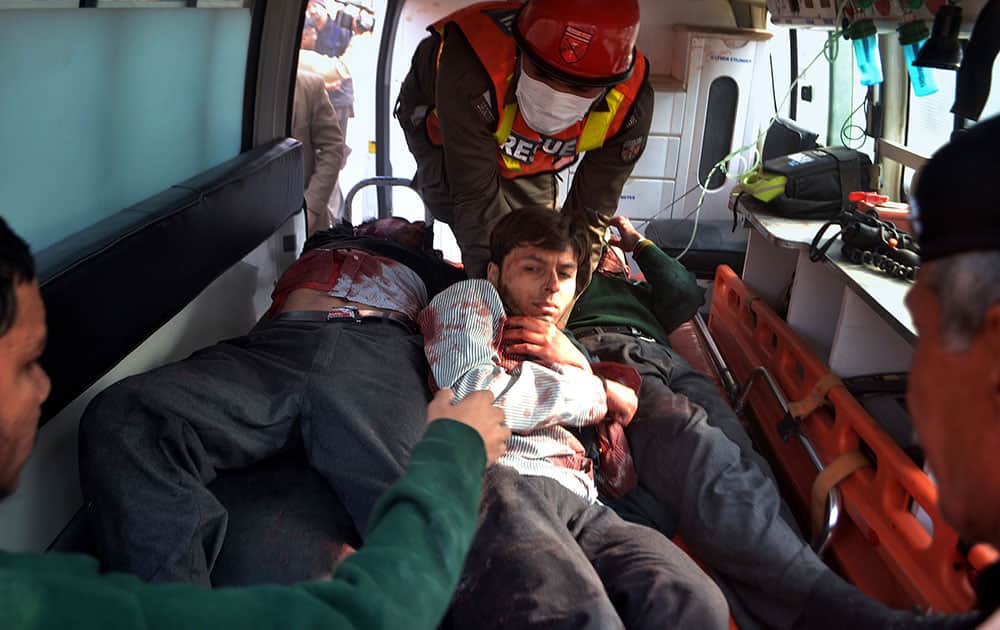 Pakistani rescue workers take out students from an ambulance who injured in the shootout at a school under attack by Taliban gunmen, upon arrival at a local hospital in Peshawar, Pakistan.
