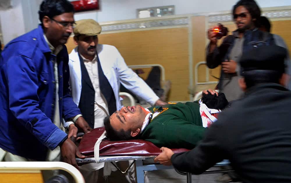 Hospital staff transport a student injured in the shootout at a school under attack by Taliban gunmen in Peshawar, Pakistan.