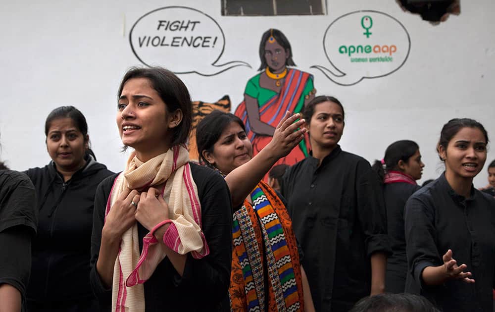 Students perform a street play to create awareness on violence against women during a protest ahead of the second anniversary of the deadly gang rape of a 23-year-old physiotherapy student on a bus, in New Delhi, India.