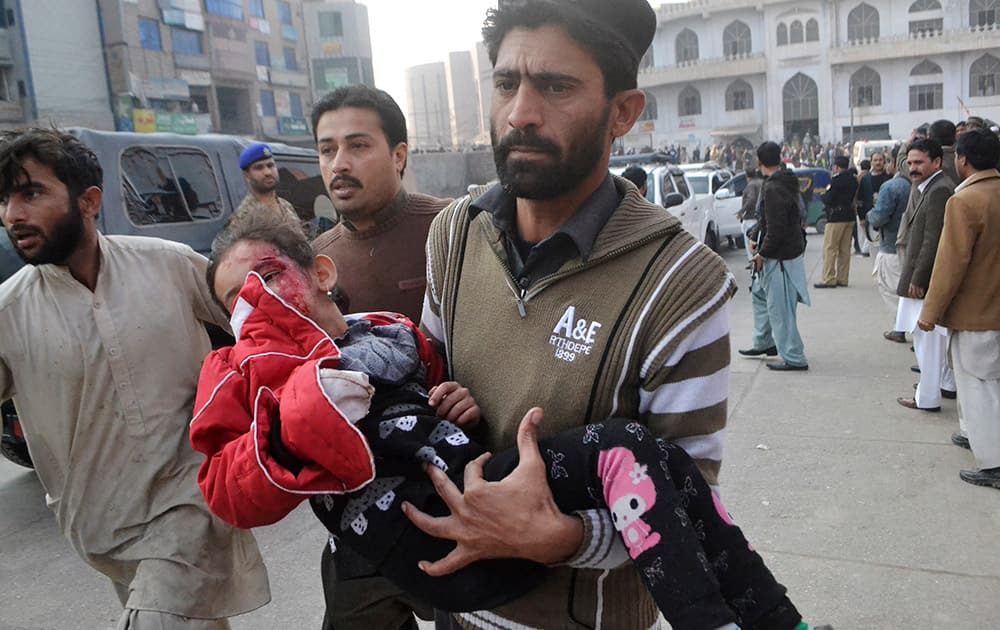 A Pakistani girl, who was injured in a Taliban attack in a school, is rushed to a hospital in Peshawar, Pakistan.