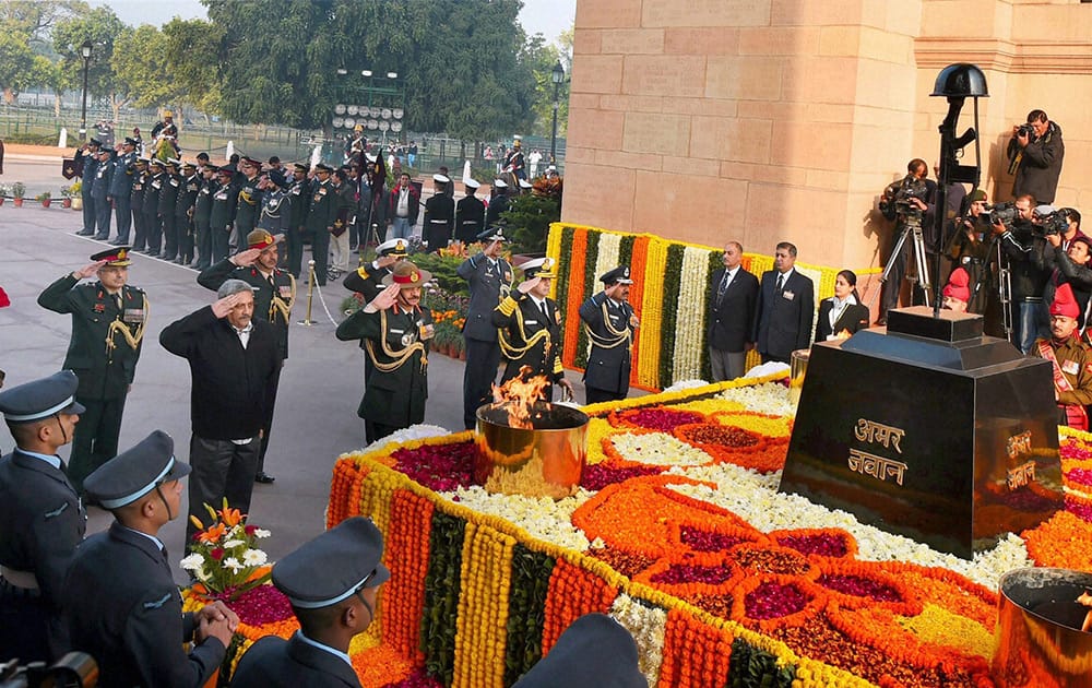 Defence Minister Manohar Parrikar along with Air Chief Marshal Arup Raha, Naval Chief Admiral RK Dhowan and Army chief Gen Dalbir Singh pays homage to the martyrs at Amar Jawan Jyoti on the occassion of Vijay Diwas in New Delhi.