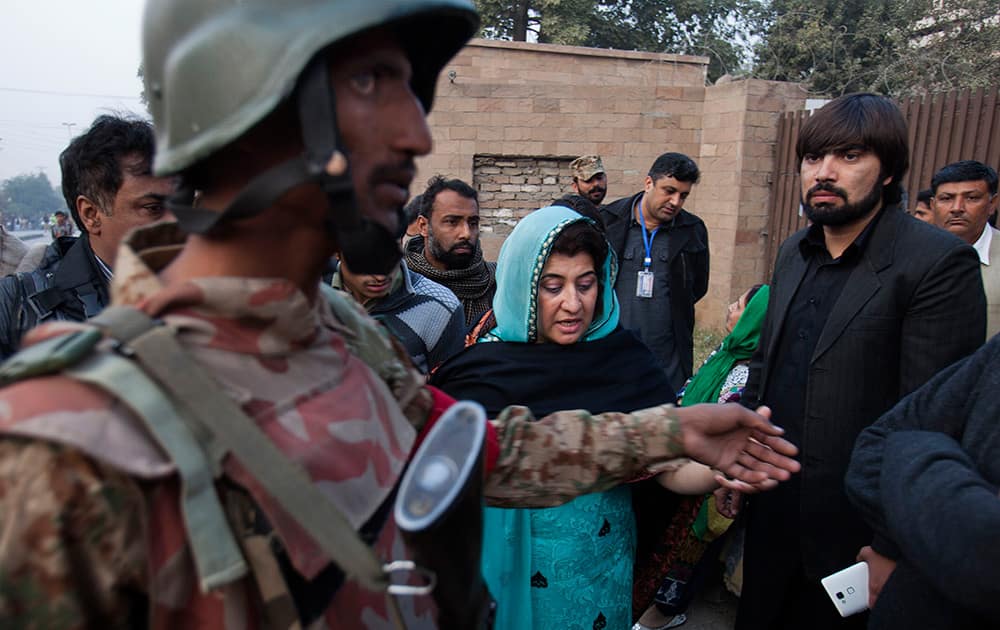 A Pakistani army soldier clears the area outside a school attacked by Taliban in Peshawar, Pakistan.