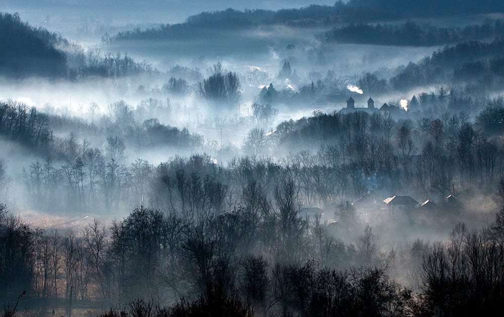 Morning fog engulfs a village outside Izbasesti, Romania. Severe fog affected large areas of Romania causing traffic disruptions.