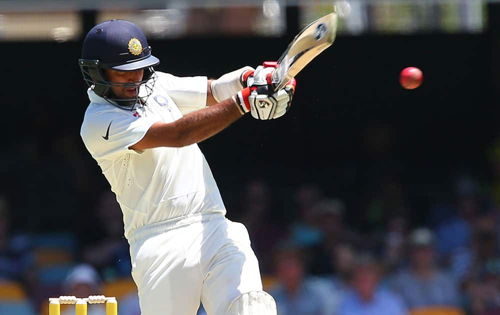 India's Murali Vijay reacts as he avoids a bouncer as his teammate Shikhar Dhawan, right, looks on during the second cricket test match between Australia and India in Brisbane, Australia