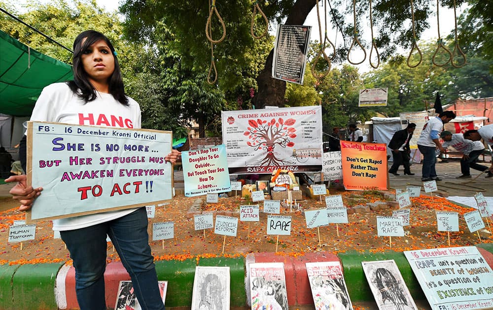 A girl holding a placard on the second anniversary of the deadly gang rape of a student on a bus, in New Delhi.