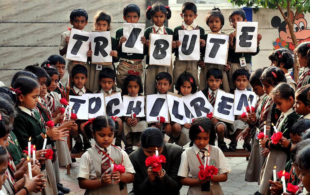 School children pay tribute to students who were killed in the terroists attack in Peshawar, in Chikmagalur in Karnataka.
