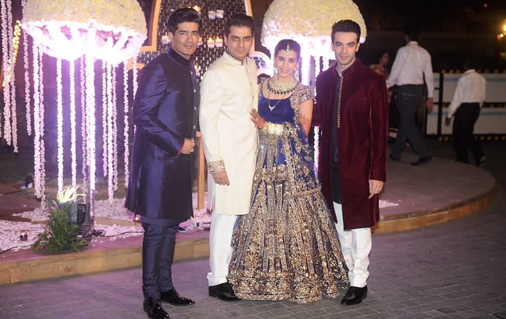 Manish Malhotra, Tejas Talwalkar, Rriddhi Malhotra and Punit Malhotra during Riddhi Malhotra and Tejas Talwalkar marriage reception in Mumbai.- dna