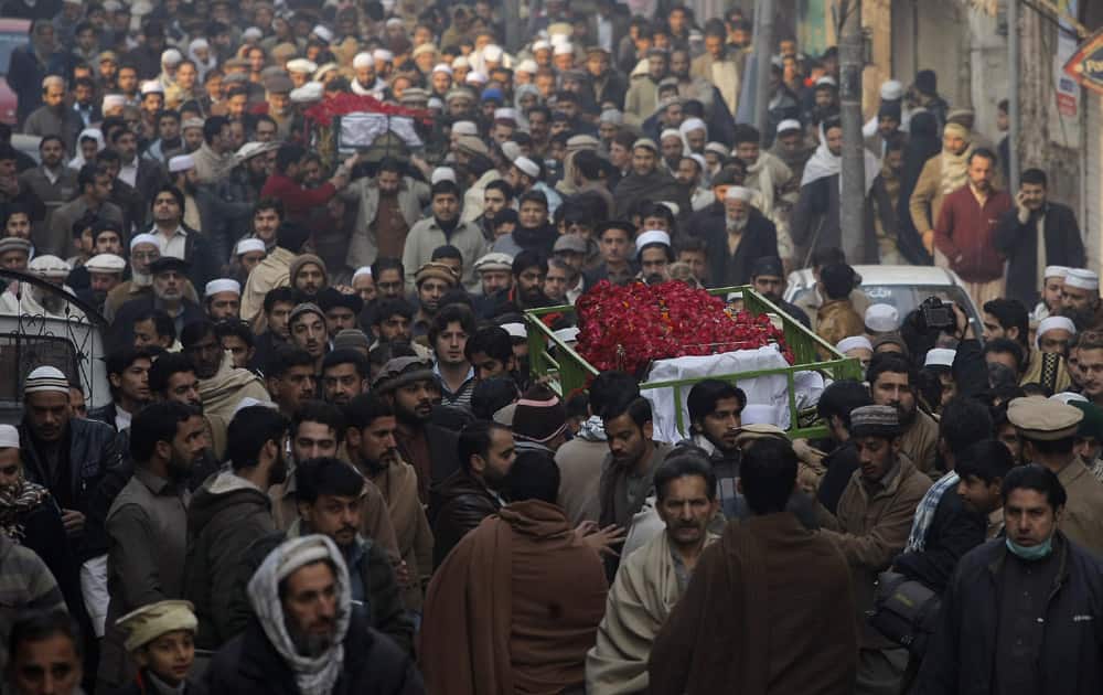 People attend funeral of a student killed in Tuesday's Taliban attack on a school in Peshawar, Pakistan.